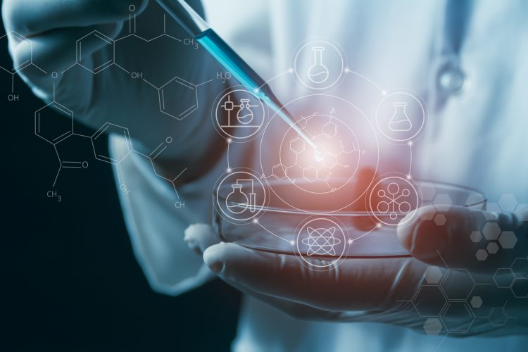 A scientist uses a pipette over a petri dish with digital molecular and chemical structure graphics, representing innovation and predictive modelling in drug discovery.