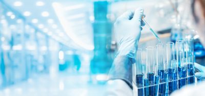 Scientist pipetting samples into test tubes in a modern laboratory, representing next-generation lab technologies and the Lab of the Future.