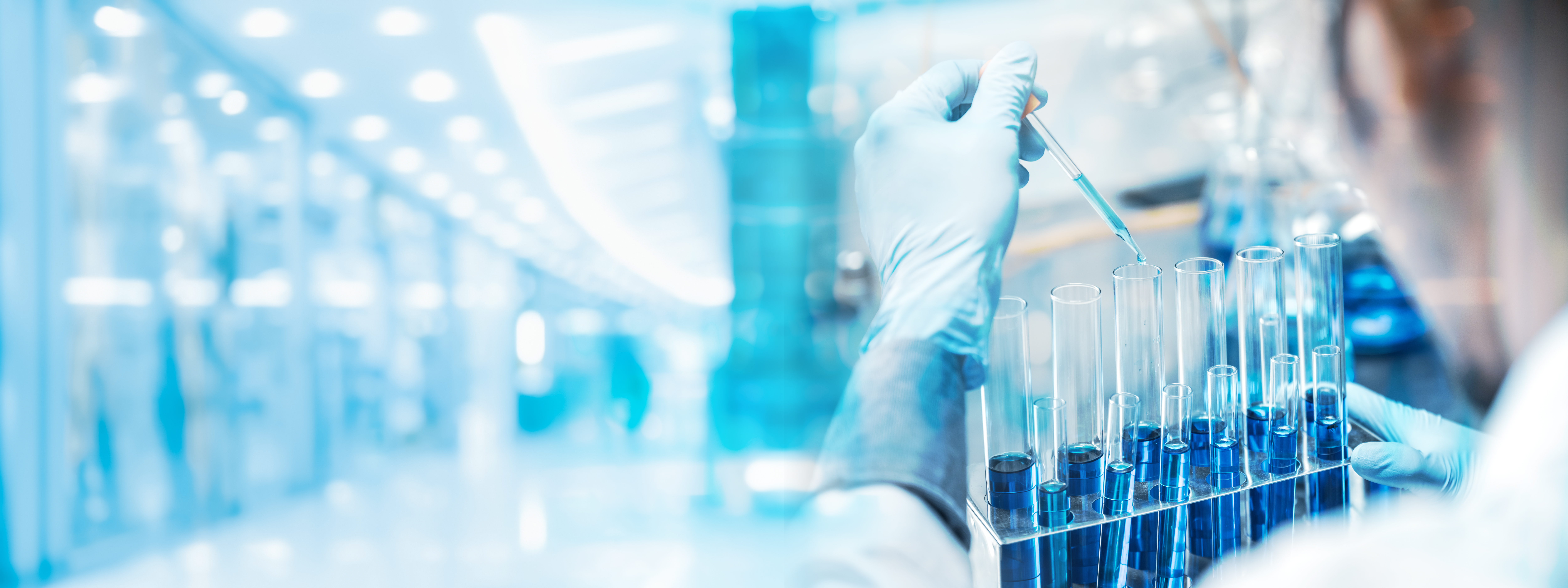 Scientist pipetting samples into test tubes in a modern laboratory, representing next-generation lab technologies and the Lab of the Future.