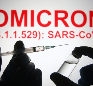 Picture of vaccine with "OMICRON" written in background