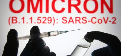 Picture of vaccine with "OMICRON" written in background