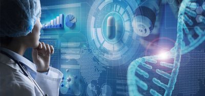 A medical researcher studies digital data visualizations showing a pill, DNA helix, and analytics charts, symbolizing the intersection of artificial intelligence, genomics, and drug discovery.