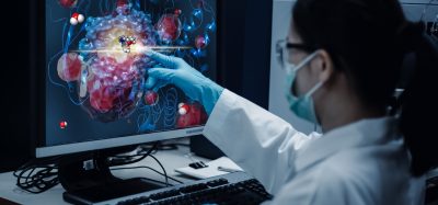 Scientist with 3D Protein Model on Screen