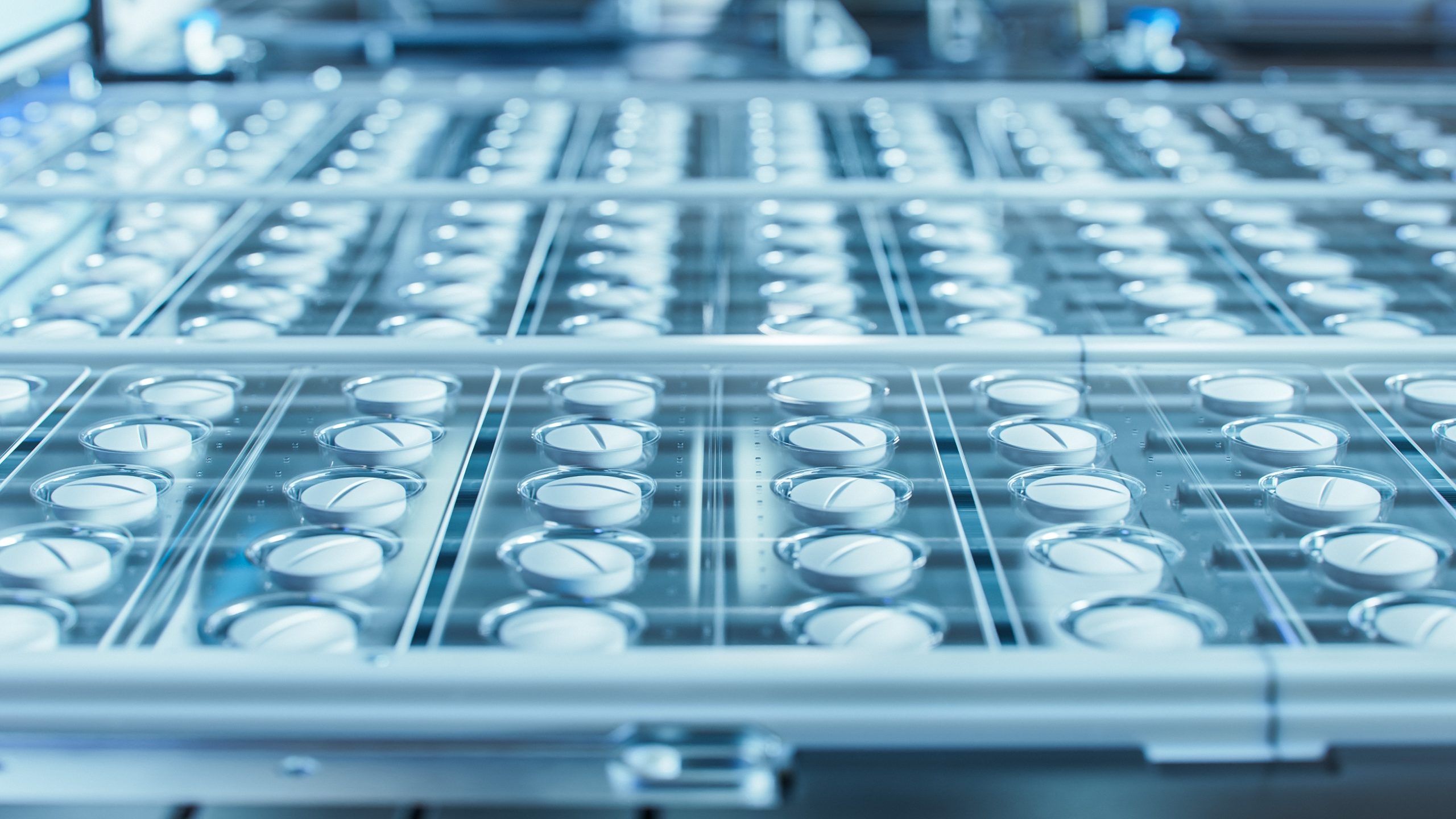 Macro Shot of White Pills During Production and Packing Process on Modern Pharmaceutical Factory. Medical Drug Manufacturing.
