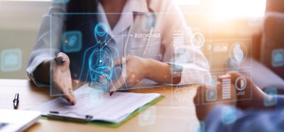 Doctor working office research studying heart disease illness, using modern computer technology display assistance artificial intelligence AI, healthcare medical staff in hospital clinic office