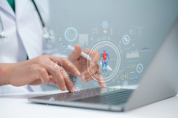 A medical researcher using a laptop with digital graphics of human anatomy, molecular data, and AI analytics overlays, symbolising the integration of artificial intelligence and biological data in drug discovery.