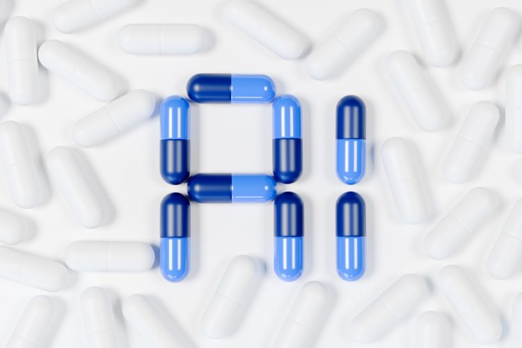 A collection of white capsules scattered on a white surface, with blue and dark blue capsules arranged in the center to form the letters 'A' and 'I'