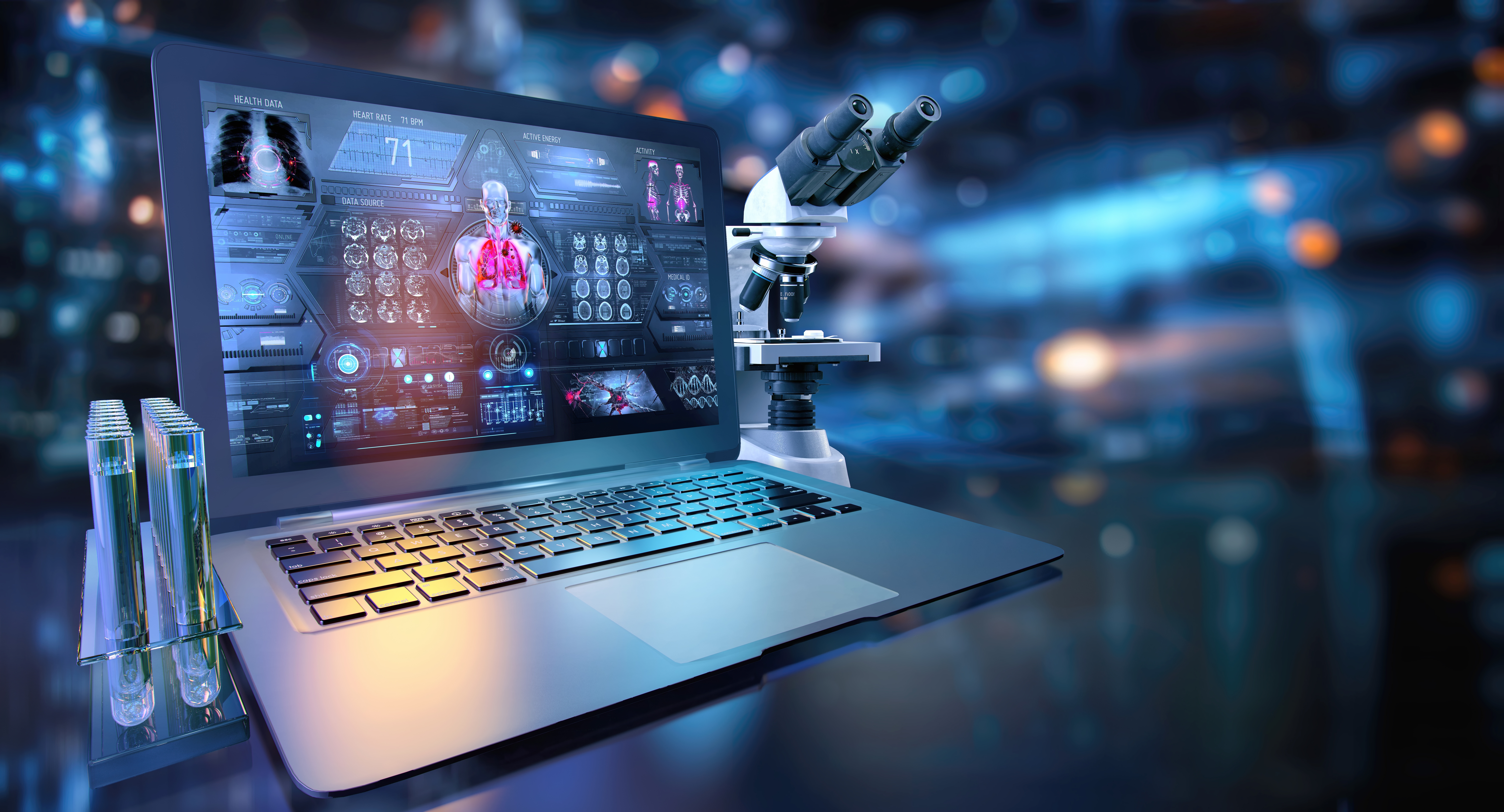A laptop displaying a digital biomedical dashboard sits beside a laboratory microscope and test tubes, representing the integration of AI, data analysis, and laboratory research.