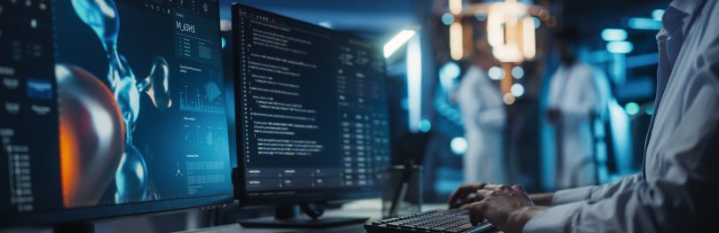 Anonymous Medical Researcher Working in Modern Office on a Desktop Computer with Molecular Modelling Software and Source Code on Screen. Biologist Designing New Drug Molecules to Combat Bacteria