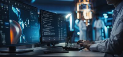 Anonymous Medical Researcher Working in Modern Office on a Desktop Computer with Molecular Modelling Software and Source Code on Screen. Biologist Designing New Drug Molecules to Combat Bacteria