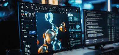 Computer screens displaying a 3D molecular structure simulation used for computational drug discovery and protein modelling.