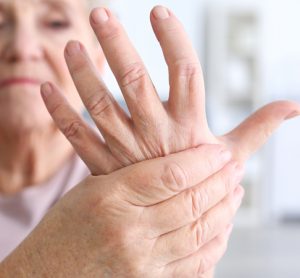 Elderly woman holding hand