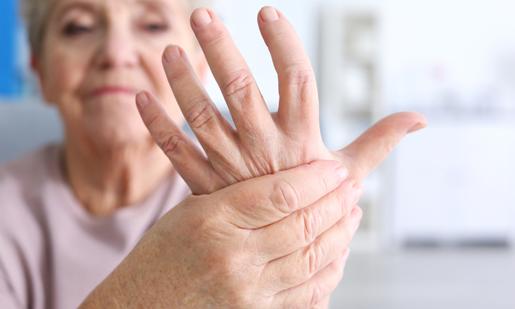 Elderly woman holding hand