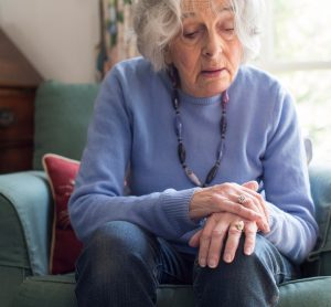 Woman with Parkinson's holding her hand