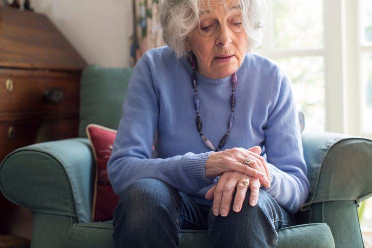 Woman with Parkinson's holding her hand