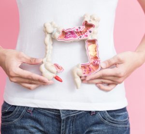 Woman holding colon model